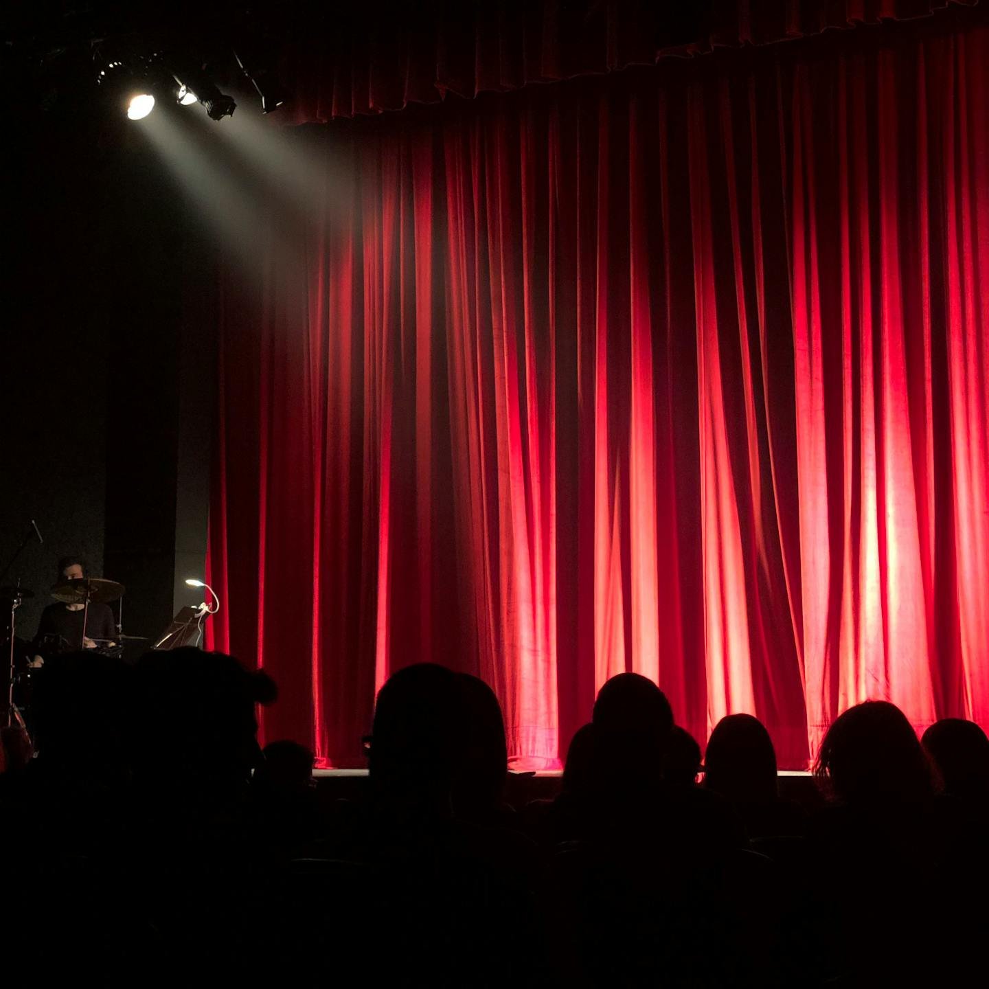 A stage with a red curtain background ready to welcome a performer stock monica 713149