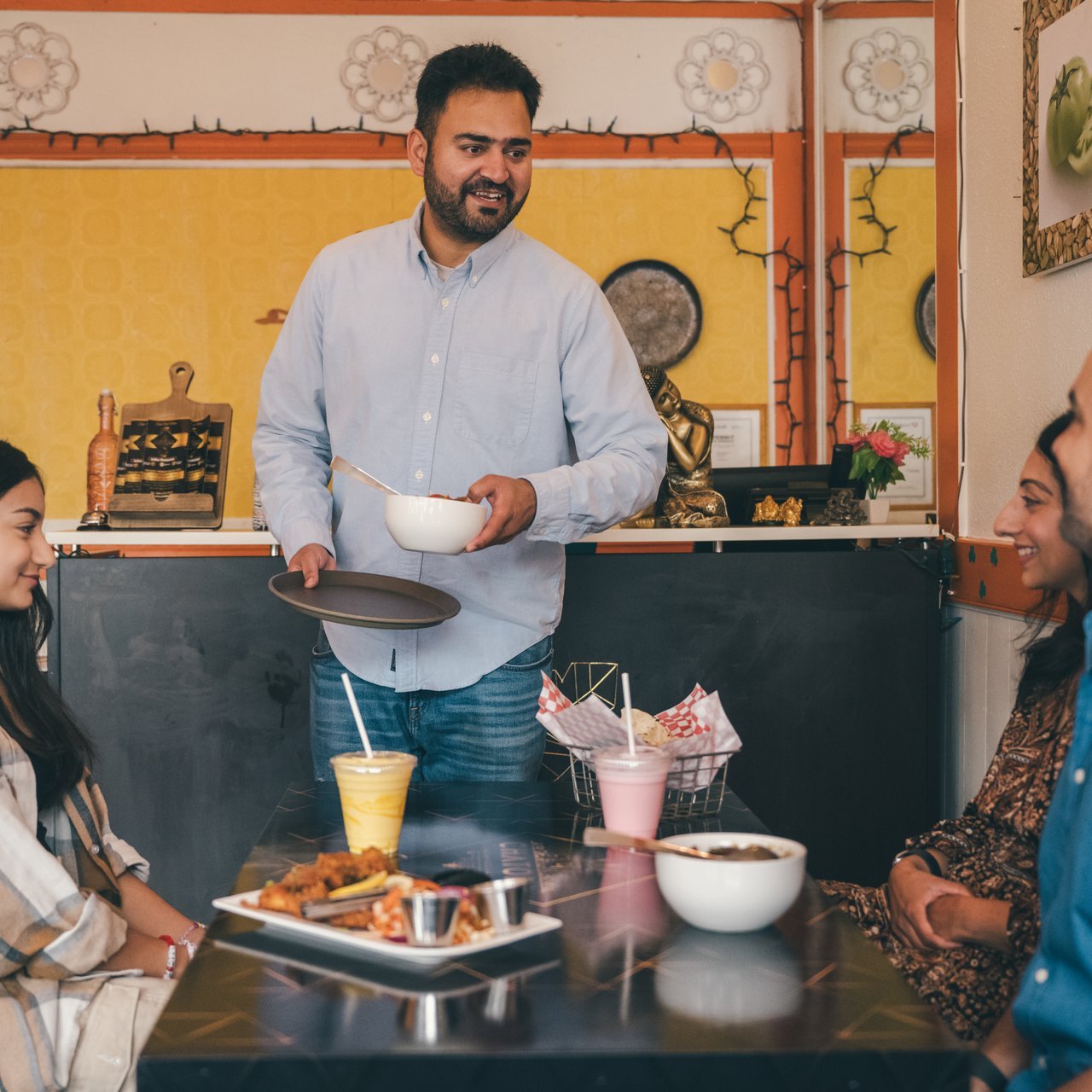 A server brings food to a family at Chatora Indian Restaurant in Cloverdale Surrey Shea MacNeilChatora 14