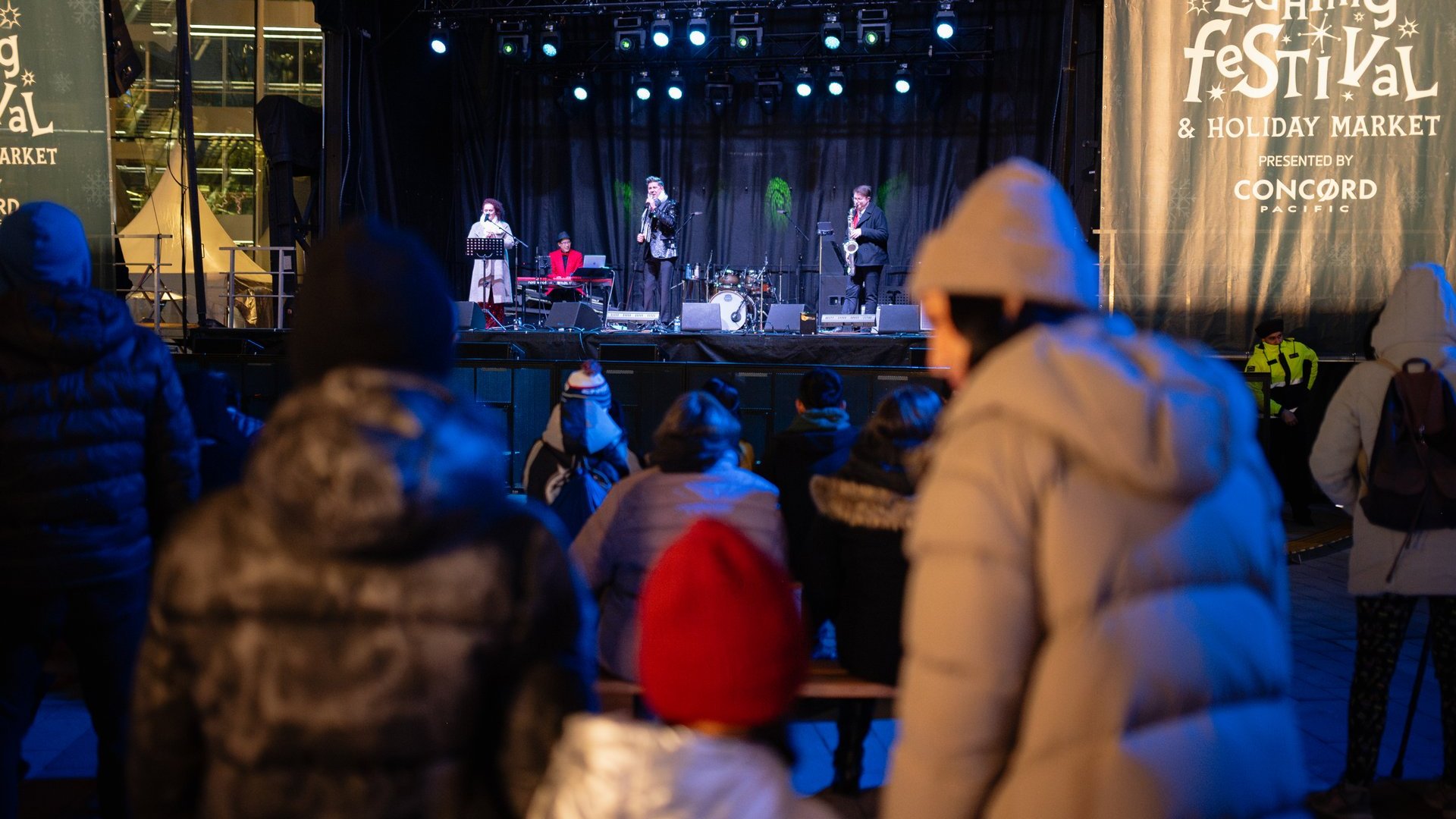 A family watches a performance at the Surrey Tree Lighting Festival at night Ian Harland DSC 7627