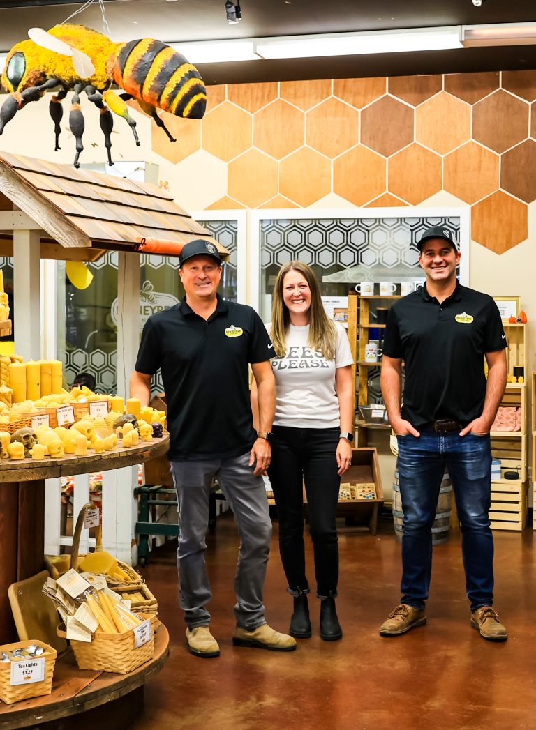 Angie Bunnell - Cloverdale - Discover Surrey - Honeybee Through My Lens - the Honeybee Centre team in the centre's store surrounded by honey products and large figures of bees