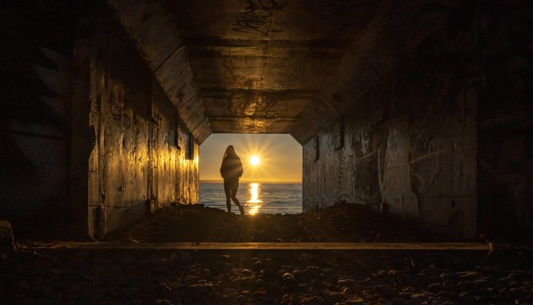 A silhouette of a person at sunset through the 1001 steps tunnel in Surrey - Roland Kaufmann - South Surrey