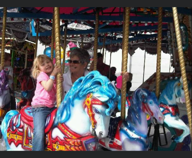 A Young fair attendee on the carousel with her grandma - Discover Surrey Through My Lens