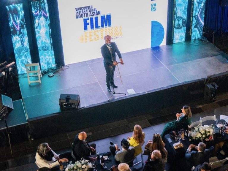 The opening keynote speaker presents on stage at the 2022 South Asian Film Festival (SAFF)